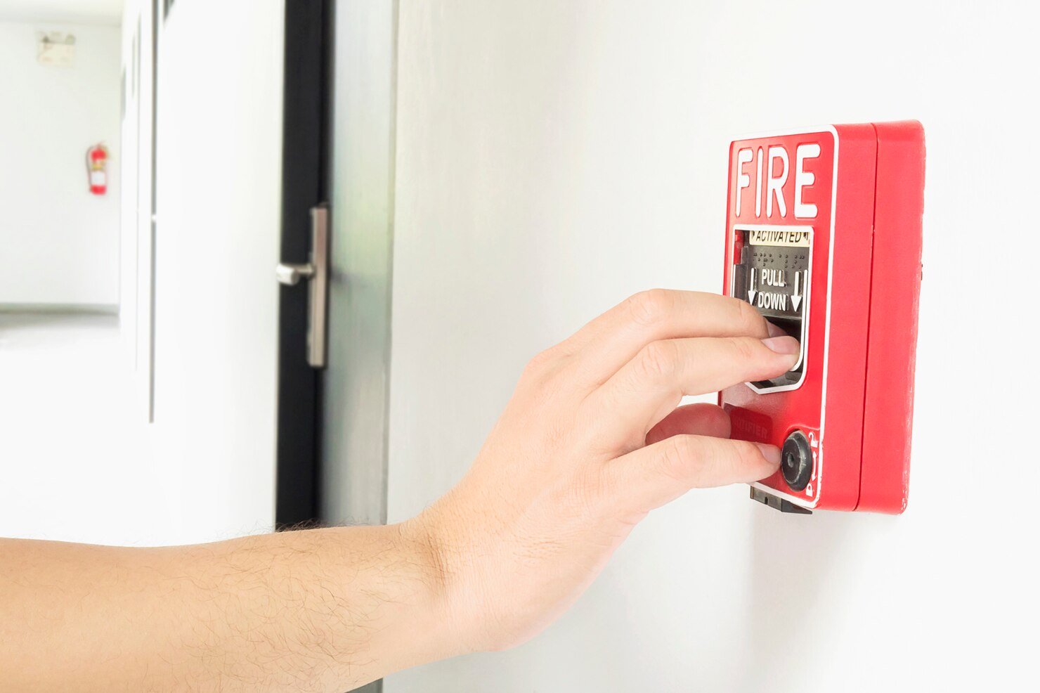 man-is-reaching-his-hand-push-fire-alarm-hand-station_1150-6187